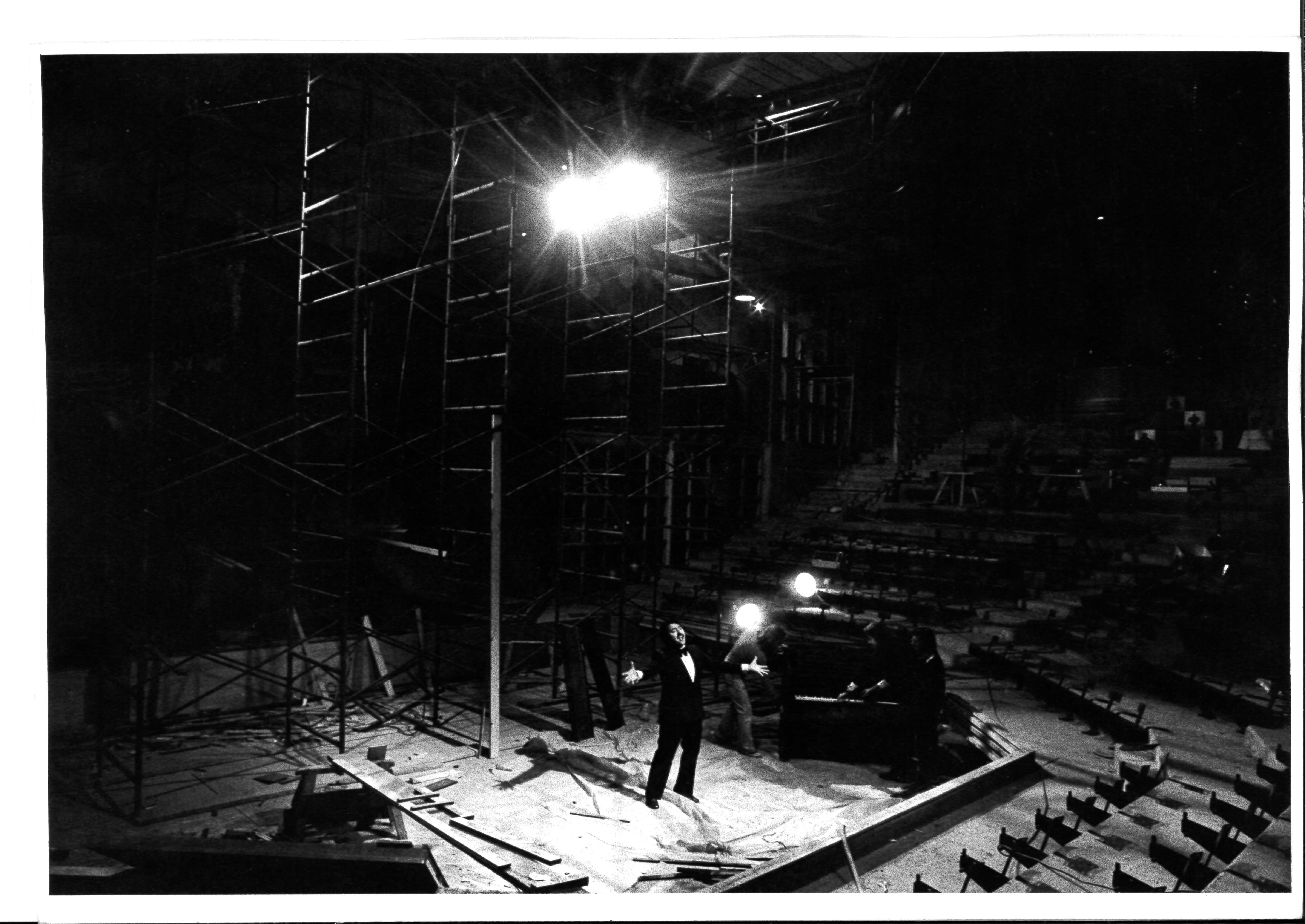 Black and white archivage image of the York Theatre stage construction with a male singer performing on stage.