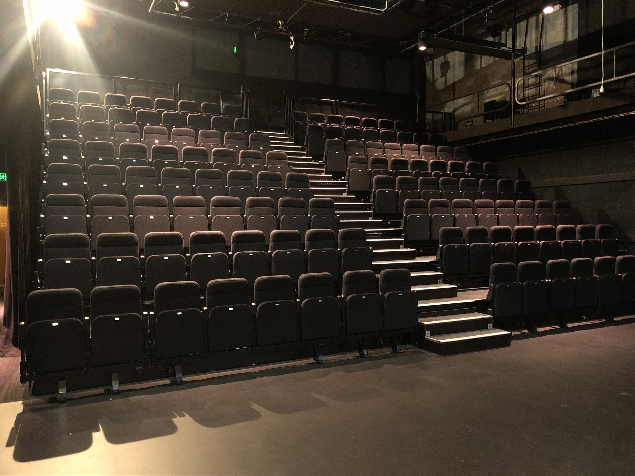 Empty Reginald Theatre seating bank viewed from the stage looking up. 