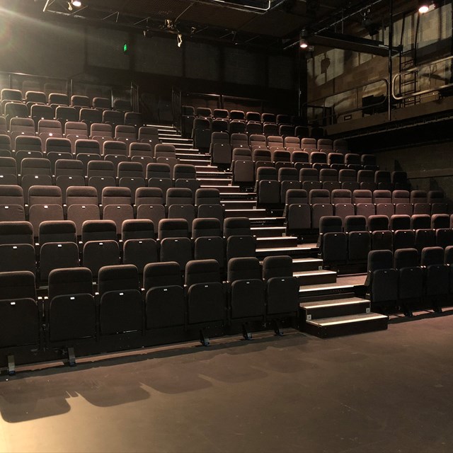 Empty Reginald Theatre seating bank viewed from the stage looking up.