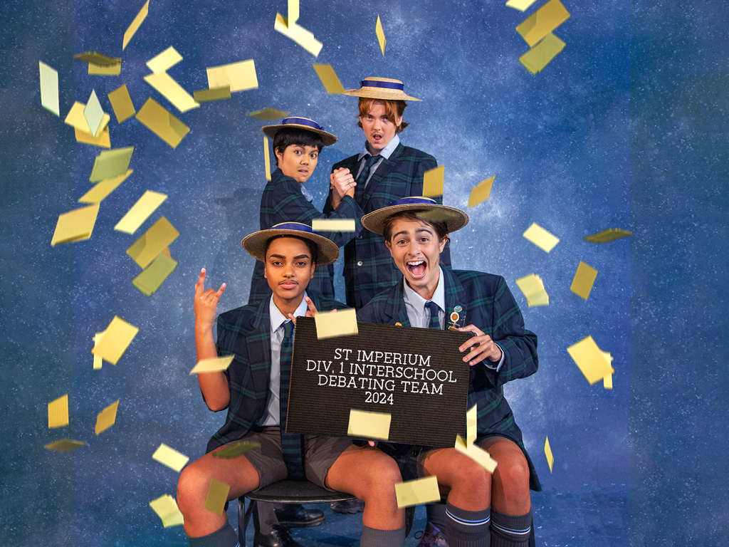 Promotional image for “Trophy Boys”, playing at Seymour Centre shows 4 actors in a school photo set holding a sign that says ' St Imperium Div.1 Interschool Debating Team 2024'.