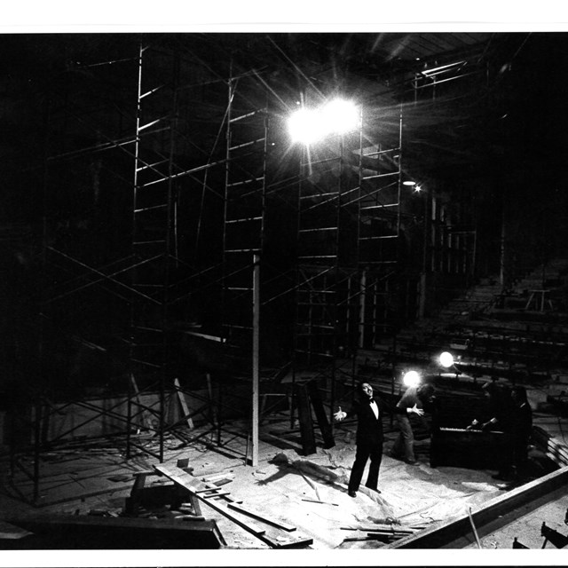 Black and white archivage image of the York Theatre stage construction with a male singer performing on stage.