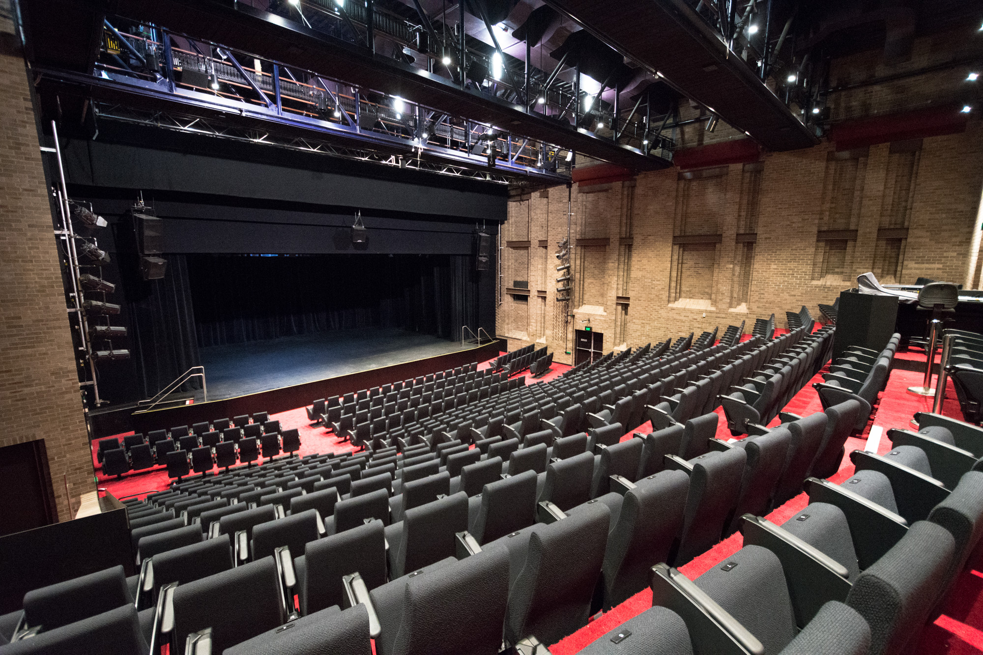 Empty Everest Theatre seating bank viewed from the top looking down towards the stage. 