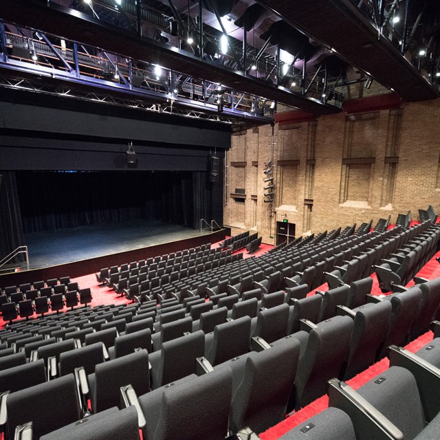 Empty Everest Theatre seating bank viewed from the top looking down towards the stage.